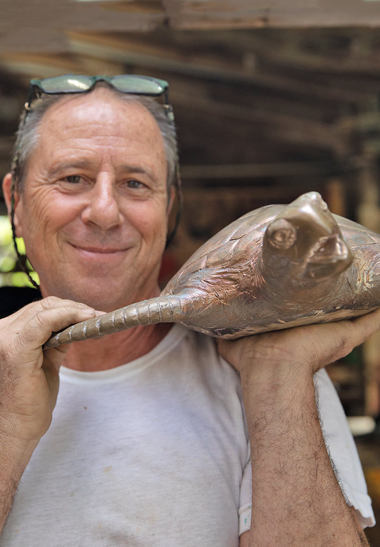 artist with a bronze turtle
