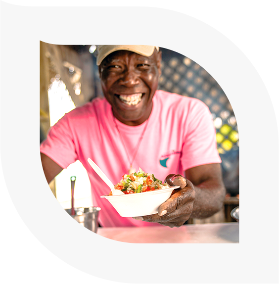 Man serving food while smiling