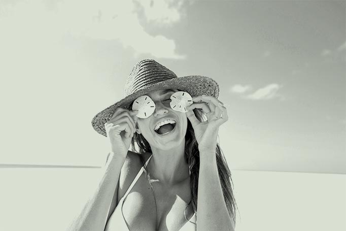 Woman holding sea stars over her eyes