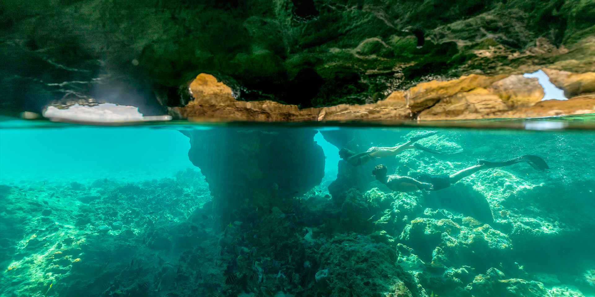 couple diving inside a cave